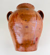 Antique Spanish terracotta jar with two handles and a wide mouth, showing amber glaze runs, reddish brown surface marks, handmade asymmetry, and age-related wear from long use. This large clay vessel supports search terms such as terracotta vase, Spanish pottery, antique vase, floor vase, and rustic farmhouse decor.
