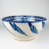 Substantial Granada pottery lebrillo with a broad circular rim, deep rounded walls and low foot, hand painted in cobalt blue and white. The exterior carries repeated flowing leaf-like brush motifs while the interior is densely patterned, giving this Spanish terracotta bowl equal presence as a fruit bowl, salad bowl or farmhouse decor centerpiece.