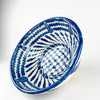 Decorated center of the Granada lebrillo bowl, featuring a cobalt blue crosshatched lattice punctuated by small flower-like brush marks and surrounded by radiating leaf forms. The expressive freehand pattern gives this large Spanish serving bowl a graphic focal point when displayed as ceramic wall art, a table centerpiece or a decorative bowl.