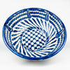 Large Spanish Fajalauza lebrillo bowl from Granada, handcrafted in glazed terracotta and painted in cobalt blue over a creamy white ground. The deep footed form combines sweeping exterior brushstrokes with an intricately decorated interior, creating a substantial serving bowl and decorative ceramic wall art piece for Mediterranean decor.