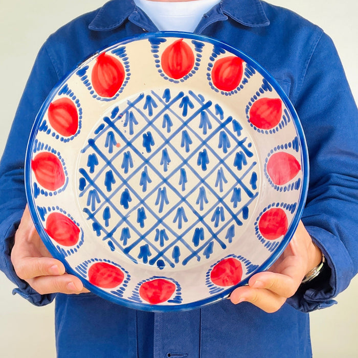 Red pomegranate Fajalauza bowl created as a contemporary Granada pottery piece with original ROC Objects design. The hand painted blue pattern, deep lebrillo shape, and white glazed interior connect the bowl to Andalusian ceramic heritage while fitting Mediterranean decor, cottage decor, and warm eclectic interiors.