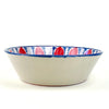Contemporary hand painted Granada Fajalauza bowl with red pomegranate motifs around the interior wall and blue geometric decoration across the central basin. The hand thrown terracotta form gives this Spanish ceramic bowl weight and depth, making it useful as decorative pottery for farmhouse decor, cottage decor, or rustic home decor.