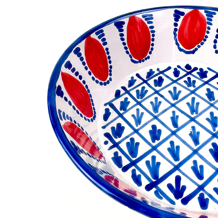 Contemporary ROC Objects Fajalauza style lebrillo bowl, hand painted and hand thrown in Granada, Spain. The red and blue decoration references Moorish-Andalusian ceramic patterning, while the deep bowl shape and terracotta body make it a strong decorative ceramic accent for cottage decor, coastal decor, and farmhouse decor.