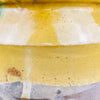 Detailed view of glaze running vertically across body surface, with visible brushwork and drip marks. The high-contrast color and matte base texture enhance its sculptural appeal for contemporary rustic or global eclectic interiors.