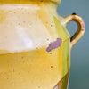 

Full angled view showing left side of the pot and two-toned glaze with green and yellow streaks over pink-hued clay. The irregular surface and hand-formed silhouette are ideal for Mediterranean rustic, French provincial, or antique country-style homes.