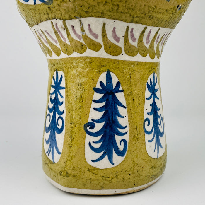 Detail of Antique French Quimper pottery with painted foliate motifs and glazed texture. The design bridges traditional Breton folk art and mid century modern abstraction, making it a rare collectible piece for organic modern decor settings.