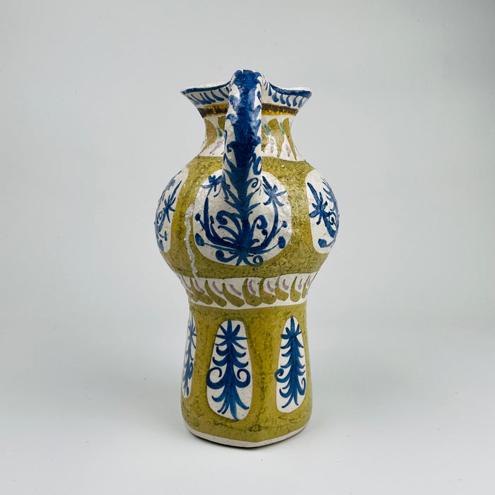 Overhead styled shot of the Vintage French Quimper vase on a linen backdrop, displaying its sculptural silhouette and vibrant glaze. Ideal for organic modern decor and French farmhouse style environments seeking rare ceramic art.
