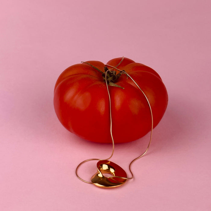 Gold-plated sculptural pendant made with lost-wax casting, designed by Laragh Stuart. This wearable sculpture represents both art jewelry and contemporary design. Organic curves, reflective finish, and bronze base highlight artisanal craftsmanship.