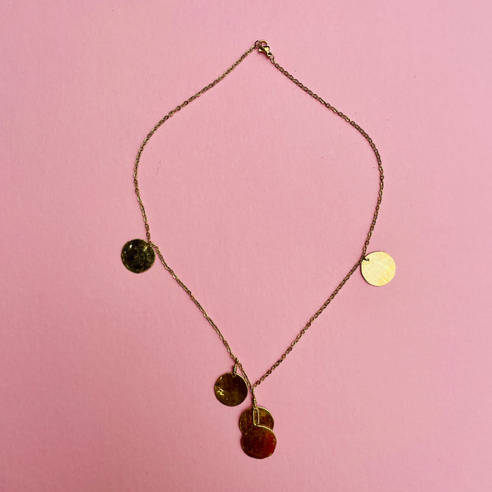 Artisan Mediterranean necklace featuring hammered coin discs, gold-tone alloy chain, and spring-ring clasp. A layering necklace designed for contemporary fashion styling, minimalist wardrobes, and summer resort collections.