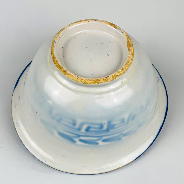 Spanish Manises blue white tin glazed bowl from Valencia region, with cobalt hand painted bird motif and scrolling foliage. The rim is organized with a Greek key meander band and saturated cobalt brushwork that creates a strong graphic border, ideal for kitchen decor, tabletop centerpiece styling, and coastal decor spaces that use blue and white ceramics.