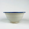 Antique Spanish tin glazed bowl attributed to Manises, Valencia region, with cobalt blue bird imagery and botanical scrolls on a white tin glaze. The rim combines a Greek key band with bold cobalt border strokes, making this a graphic decorative bowl for kitchen decor, dining table styling, or shelf display in coastal decor and farmhouse decor homes.