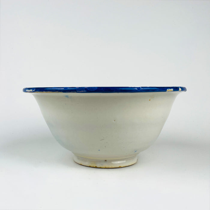 Antique Spanish tin glazed bowl attributed to Manises, Valencia region, with cobalt blue bird imagery and botanical scrolls on a white tin glaze. The rim combines a Greek key band with bold cobalt border strokes, making this a graphic decorative bowl for kitchen decor, dining table styling, or shelf display in coastal decor and farmhouse decor homes.