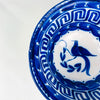 Antique Manises bowl from Spain in white tin glazed earthenware, featuring cobalt blue hand painted decoration with a bird motif and curling plant forms. The border includes a Greek key pattern and deep cobalt brushwork around the rim, ideal for a table centerpiece, decorative bowl display, or blue white ceramic accent in rustic home decor and coastal decor.