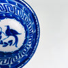 Spanish Manises tin glazed ceramic bowl with cobalt bird motif, botanical branch, and a structured Greek key border in deep blue. The opaque white glaze and layered cobalt border create a classic blue white decorative bowl presence for kitchen decor, dining room styling, or open shelving, fitting Mediterranean decor and French country decor palettes.
