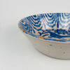 Vintage Spanish ceramic bowl attributed to Granada Fajalauza, tin glazed earthenware with cobalt blue brushwork. The central bird and rosette flower motif is surrounded by scrolling foliage and a wavy rim border. Use for serving salads, lemons, or bread, and as a decorative bowl in wabi sabi decor where handmade glaze surfaces and traditional forms add texture to calm interiors.