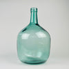 Vintage blue glass demijohn vase from Spain, marked V. Ayelense on the neck and originally made as a wine carboy or damajuana. The aqua blue green glass has a rounded body, narrow neck, visible bubbles, mould seams, and irregular surface movement, making it suitable as Mediterranean decor, coastal decor, or a large glass vase.