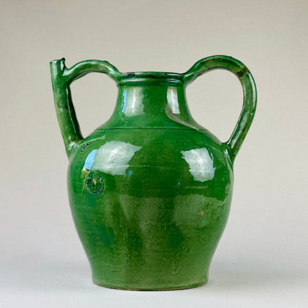 Full view of antique French green terracotta gargolette standing upright against neutral background
This long-necked antique French green terracotta gargolette water jug is shown in full upright profile, highlighting its double-handle construction, vibrant emerald green glaze, and sculptural farmhouse silhouette—perfect for Mediterranean or rustic interior styling.