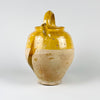 French country decor piece in the form of a large yellow gargoulette pot, made from antique terracotta pottery with a glazed upper body and unglazed lower body. The water jug has a lid, spout, and handles, with aged surface texture and glaze wear that add depth to a rustic kitchen, farmhouse decor setting, or Mediterranean interior.