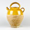 French yellow glazed terracotta gargoulette pot with lid, made as a practical water jug and now used as a decorative ceramic object. The warm ochre glaze, unglazed lower body, rounded form, short pouring spout, arched handle, and worn surface give the piece strong presence for Mediterranean decor, farmhouse decor, and vintage kitchen display.