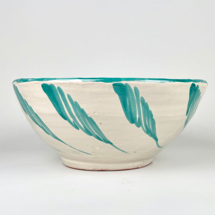 Farmhouse decor accent made from Spanish glazed terracotta, with a hand painted Fajalauza green bird design inside a large lebrillo bowl. The cream ground, turquoise green rim, loose brushwork, floral motifs, and terracotta body create a decorative ceramic bowl for wall display, serving display, or vintage home decor.