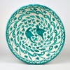 Large Spanish Fajalauza lebrillo bowl in hand painted green terracotta, with a cream white glazed ground, twin bird motif, scrolling foliage, floral decoration, and a green rim. The deep rounded form and pierced reverse hole make it suitable as a decorative bowl, ceramic wall hanging, or Mediterranean decor object.