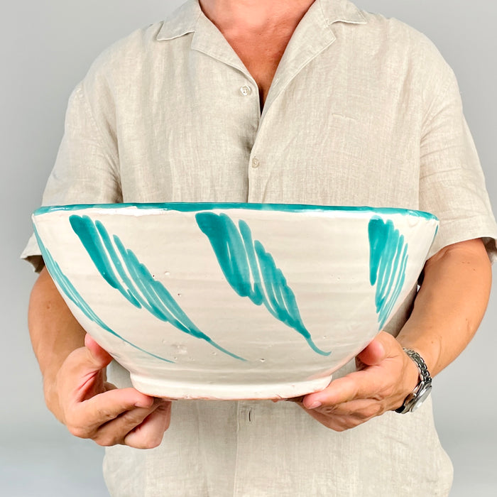 Spanish Fajalauza lebrillo bowl with hand painted green birds at the center, surrounded by flowers, scrolling leaves, and a repeating border. Made from glazed terracotta in the Granada pottery tradition, this large ceramic bowl can be displayed as wall art, a table centerpiece, or a Spanish pottery accent for farmhouse decor.