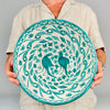 Large Granada ceramic bowl in the Fajalauza tradition, decorated in green over a cream glazed surface with two birds, floral details, leafy scrolls, and a painted rim. The terracotta bowl has a strong wall hanging presence and works well as Mediterranean decor, rustic home decor, or a collected Spanish ceramic object.