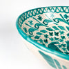 Large Spanish ceramic bowl in Fajalauza style, with green hand painted birds, small flowers, leafy scrolls, and a cream white glazed interior. The terracotta body, rounded lebrillo shape, green rim, and reverse hanging hole make it a decorative wall bowl for Spanish pottery collectors and Mediterranean interiors.