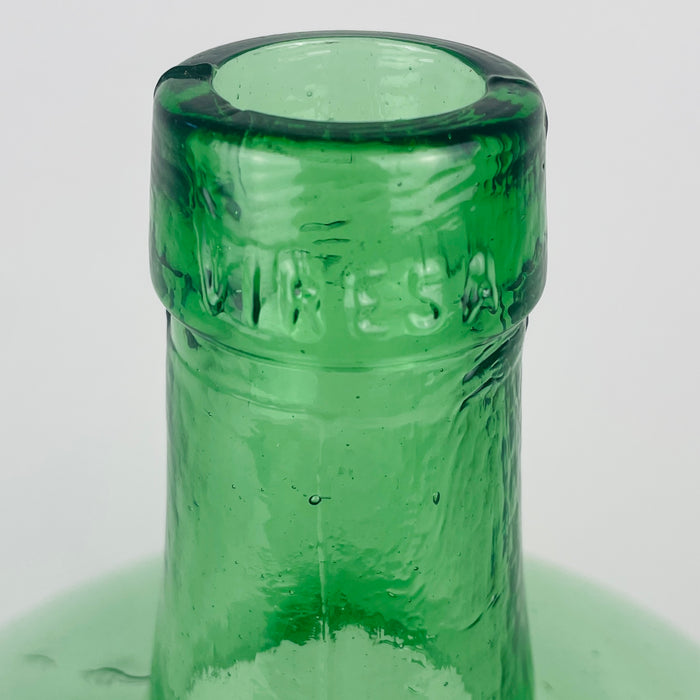 Rounded profile of a circa 1960s VIRESA wine carboy from Benigànim, Valencia, made from mould blown green glass with a 5 L capacity. The wide body, curved shoulder, elongated neck and thick mouth create a balanced bottle vase silhouette, while natural ripples and bubbles add depth. It is well suited to dried branches and understated wabi sabi decor.