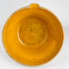 Side view of the antique French terracotta bowl highlighting the partially glazed exterior band and raw terracotta lower body. The warm amber ochre interior contrasts with the natural clay beneath, illustrating historic firing practices of Southwest and Central France. This large piece is ideal for French country decor, rustic table settings, or as a bold accent on kitchen islands and open shelving.