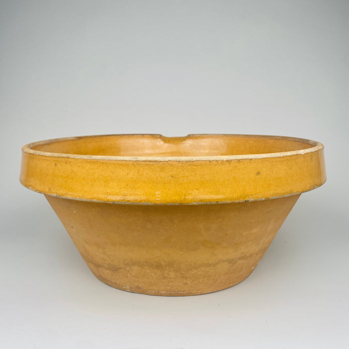 Close detail of the rim demonstrates glaze thickness, clay body texture, and the subtle asymmetry of hand thrown terracotta. The warm amber ochre glaze highlights the craftsmanship of late 19th century French pottery. Ideal for farmhouse decor, cottage kitchen decor, and Mediterranean homes.
