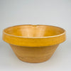 Close detail of the rim demonstrates glaze thickness, clay body texture, and the subtle asymmetry of hand thrown terracotta. The warm amber ochre glaze highlights the craftsmanship of late 19th century French pottery. Ideal for farmhouse decor, cottage kitchen decor, and Mediterranean homes.