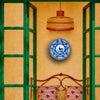 antique Spanish charger designed for hanging, with two holes integrated into the raised foot ring and a broad decorated face that reads clearly on a wall. The cobalt bird, botanical branch, radial leaves, and geometric sections make this Talavera majolica an effective centerpiece for gallery wall decor.