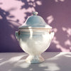 Mid Century Modern French decorative bowl in white glazed earthenware, combining a domed lid, rounded finial, twin handles, bulbous body, and flared pedestal foot. The large ceramic tureen has a softly distressed surface and sculptural silhouette for French country decor, wabi sabi decor, or Mediterranean home decor.